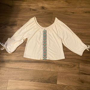 Ivory cream geo panel cold shoulder style blouse. Brand is Poof!    Size S